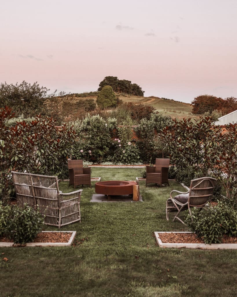 Fire pit in the secret garden at Calstock Estate, providing a cozy setting for guests